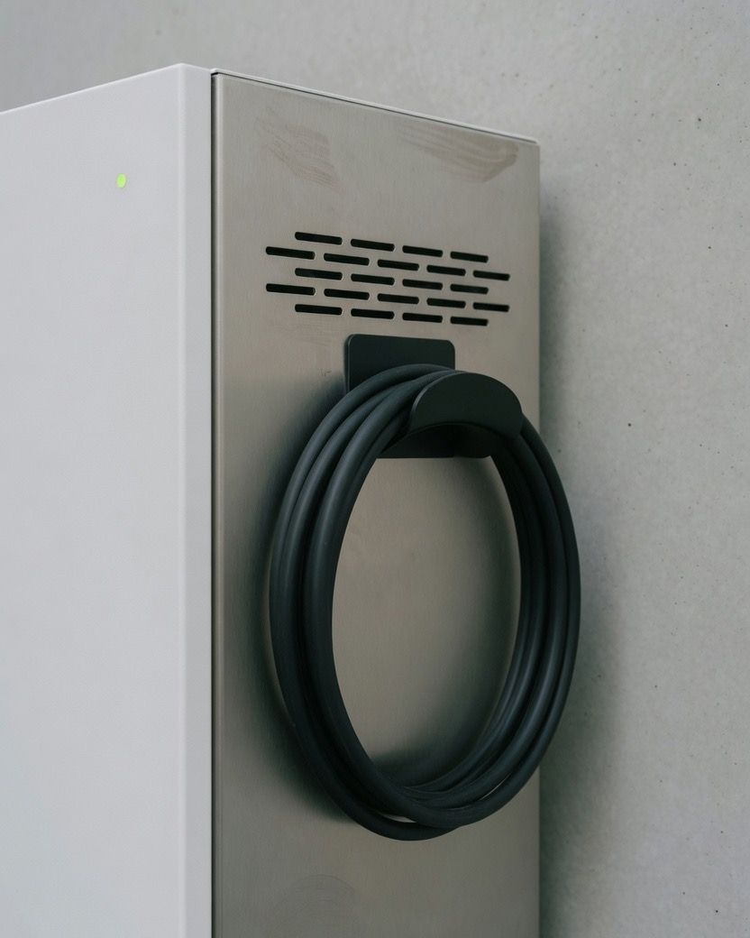 Side of a fast charger, with the cable coiled on the holster and the plug stowed.